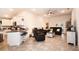 Open-concept living room with tile floors, neutral color palette, and access to kitchen and outdoor area at 4509 95Th E Ter, Parrish, FL 34219