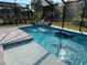 Backyard pool with sun-kissed water, and a shark float, surrounded by lush greenery at 4509 95Th E Ter, Parrish, FL 34219