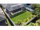 View of the backyard with a screened in pool and a well maintained lawn at 4578 Cedar Brush Ter, Sarasota, FL 34243