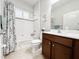 Cozy bathroom features wood vanity, white tiled shower, and a shower curtain at 4578 Cedar Brush Ter, Sarasota, FL 34243