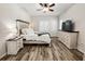 Inviting primary bedroom with wood-look flooring, ceiling fan, and decorative furnishings at 4578 Cedar Brush Ter, Sarasota, FL 34243
