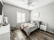 Bedroom with wood-look flooring and shuttered window at 4578 Cedar Brush Ter, Sarasota, FL 34243