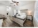 Bright bedroom with wood-look flooring, ceiling fan, and decorative furnishings at 4578 Cedar Brush Ter, Sarasota, FL 34243