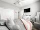 Bright bedroom features a ceiling fan, closet, TV, and gray walls at 4578 Cedar Brush Ter, Sarasota, FL 34243
