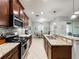Beautiful kitchen featuring dark wood cabinets, stainless steel appliances, and a dining area at 4578 Cedar Brush Ter, Sarasota, FL 34243