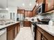 Modern kitchen with stainless steel appliances, granite countertops, and tile backsplash at 4578 Cedar Brush Ter, Sarasota, FL 34243