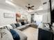 Open-concept living room with a spacious sectional sofa, stylish decor, and a view of the kitchen at 4578 Cedar Brush Ter, Sarasota, FL 34243