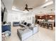 Open-concept living room with a sectional, a kitchen, and access to the patio at 4578 Cedar Brush Ter, Sarasota, FL 34243