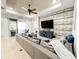 Cozy living room with a large sectional sofa, modern ceiling fan, and sliding glass doors at 4578 Cedar Brush Ter, Sarasota, FL 34243