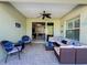 Screened patio features a ceiling fan and comfortable wicker furniture at 4578 Cedar Brush Ter, Sarasota, FL 34243