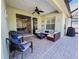 Comfortable screened patio features ceiling fan, wicker furniture, and pool view at 4578 Cedar Brush Ter, Sarasota, FL 34243