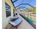 Extended screened patio with poolside lounging and views of the private, fenced backyard at 4578 Cedar Brush Ter, Sarasota, FL 34243
