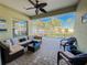 Screened-in patio features comfortable wicker furniture and ceiling fan at 4578 Cedar Brush Ter, Sarasota, FL 34243