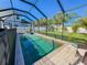Screened pool with brick paver deck and lush tropical landscaping offers a relaxing outdoor living space at 4578 Cedar Brush Ter, Sarasota, FL 34243