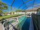 Backyard features screened pool, spa, green grass and white fence at 4578 Cedar Brush Ter, Sarasota, FL 34243