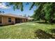 Large backyard with ample lawn space and a partially screened in patio, perfect for outdoor enjoyment at 4673 Lummus St, North Port, FL 34286