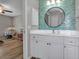 Bright bathroom featuring blue tile backsplash, white vanity, and views to an adjacent bedroom at 4673 Lummus St, North Port, FL 34286