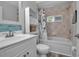 Well-lit bathroom with a tub-shower combination, white vanity, and stylish blue tile backsplash at 4673 Lummus St, North Port, FL 34286