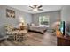 Comfortable bedroom with a plush chair, footrest, bedside tables, and ample natural light at 4673 Lummus St, North Port, FL 34286