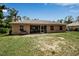 Exterior home view with a screened-in patio, set in a spacious backyard with room to enjoy the outdoors at 4673 Lummus St, North Port, FL 34286
