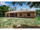 The back exterior of the home features a screened in patio and a spacious backyard at 4673 Lummus St, North Port, FL 34286