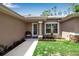 Close-up of a welcoming front entry with a chair and decorative plants at 4673 Lummus St, North Port, FL 34286