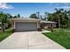 Inviting single-Gathering home showcasing a spacious driveway and well-maintained landscaping at 4673 Lummus St, North Port, FL 34286