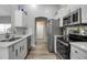 Bright kitchen with stainless steel appliances, white cabinetry, and modern countertops at 4673 Lummus St, North Port, FL 34286
