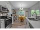 Bright kitchen area with stainless steel appliances and an adjacent breakfast nook at 4673 Lummus St, North Port, FL 34286