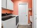 A practical laundry room featuring white cabinets, modern appliances, and a deep utility sink at 4673 Lummus St, North Port, FL 34286