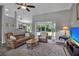 Inviting living room featuring hardwood floors, neutral walls, access to kitchen and glass door to patio at 4673 Lummus St, North Port, FL 34286