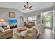 Inviting living room with cozy furniture, neutral walls, wood-look floors and ample natural light at 4673 Lummus St, North Port, FL 34286