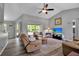 Comfortable living room featuring hard surface floors, large windows, and a ceiling fan at 4673 Lummus St, North Port, FL 34286