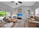 Bright living room featuring vaulted ceiling, neutral paint, wood-look floors, and sliding door to lanai at 4673 Lummus St, North Port, FL 34286