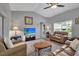 Inviting living room featuring vaulted ceiling, neutral walls, hardwood floors, and ample seating at 4673 Lummus St, North Port, FL 34286