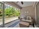 Inviting screened-in patio featuring cozy seating and serene views of the lush backyard at 4673 Lummus St, North Port, FL 34286
