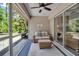 Relaxing screened-in patio with comfortable seating and a ceiling fan, seamlessly connected to the living area at 4673 Lummus St, North Port, FL 34286