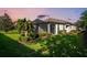 Beautifully landscaped backyard with a screened lanai, lush lawn, and manicured hedges at 4704 Stafford Ct, Palmetto, FL 34221