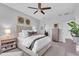 Well-lit bedroom featuring a comfortable bed, side tables, and decorative wall art creating a cozy atmosphere at 4704 Stafford Ct, Palmetto, FL 34221