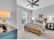 Cozy bedroom with soft lighting, featuring a wooden bed frame, side tables, and a ceiling fan at 4704 Stafford Ct, Palmetto, FL 34221