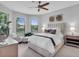 Bright bedroom featuring plush bedding, neutral tones, and ample natural light from large windows with views at 4704 Stafford Ct, Palmetto, FL 34221