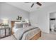 Comfortable bedroom with neutral decor, featuring a bed, side table, and access to an ensuite bathroom at 4704 Stafford Ct, Palmetto, FL 34221