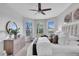 Bright bedroom with bay window, ceiling fan, dresser and king bed at 4704 Stafford Ct, Palmetto, FL 34221