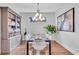 Dining room displaying a well-decorated table, modern lighting, and stylish bookshelf at 4704 Stafford Ct, Palmetto, FL 34221
