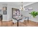 Dining room setup with a modern chandelier, glass table, and ample seating at 4704 Stafford Ct, Palmetto, FL 34221