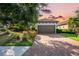 Charming home with a two-car garage, lovely landscaping, brick driveway, and tile roof at 4704 Stafford Ct, Palmetto, FL 34221