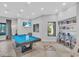 Entertaining game room includes a pool table, comfy seating, and a library at 4704 Stafford Ct, Palmetto, FL 34221