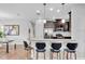 An open-concept kitchen and dining area with modern bar stool seating at 4704 Stafford Ct, Palmetto, FL 34221