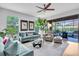 Bright living room with hardwood floors, stylish furniture, and sliding glass doors to outdoor space at 4704 Stafford Ct, Palmetto, FL 34221