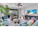 Bright living room featuring neutral walls, fan, hard floors, and sliding glass doors at 4704 Stafford Ct, Palmetto, FL 34221